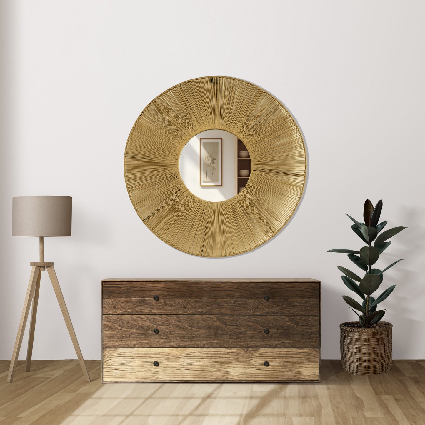 A round wall mirror with a golden aura created by radiating jute threads and a reflective iron frame, mounted on a white wall.