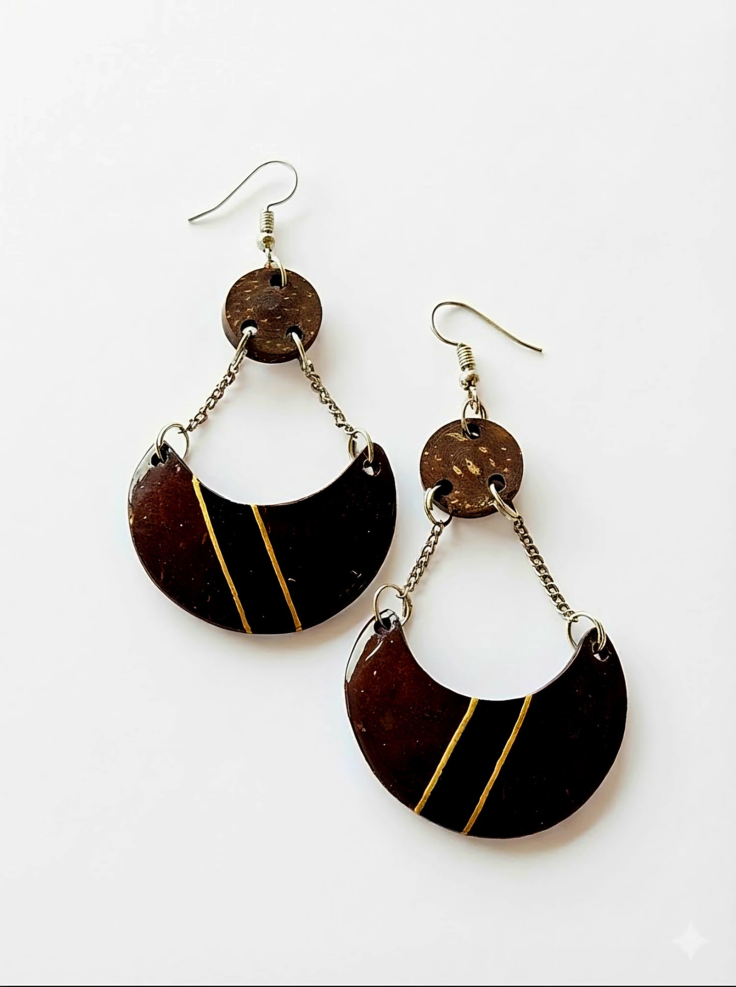 Pair of black and gold earrings on a white background