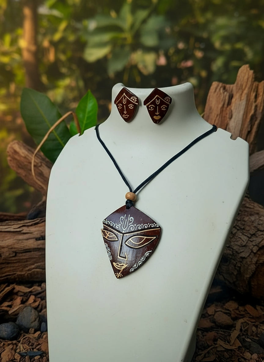 Jewelry set with pendant and earrings on a mannequin bust against a natural background.