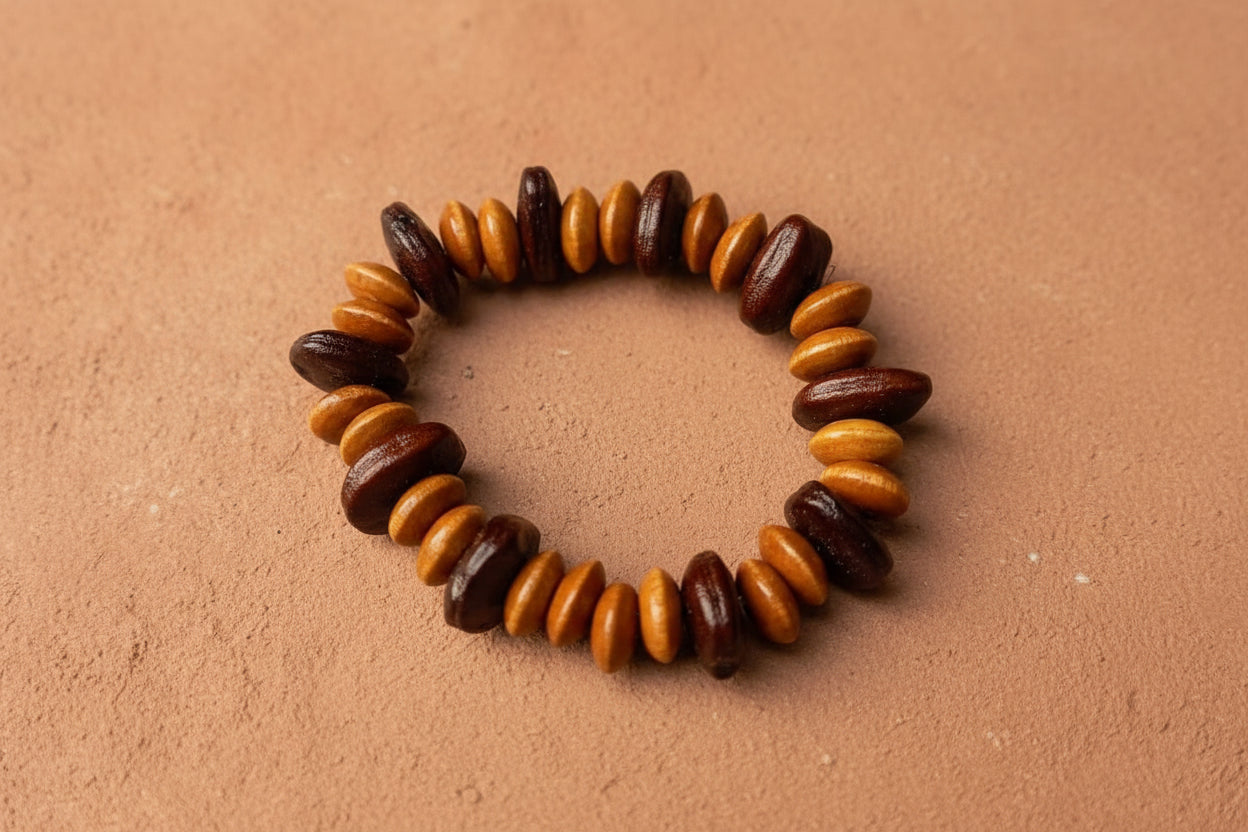 Beaded bracelet with brown and orange beads on a light gray background