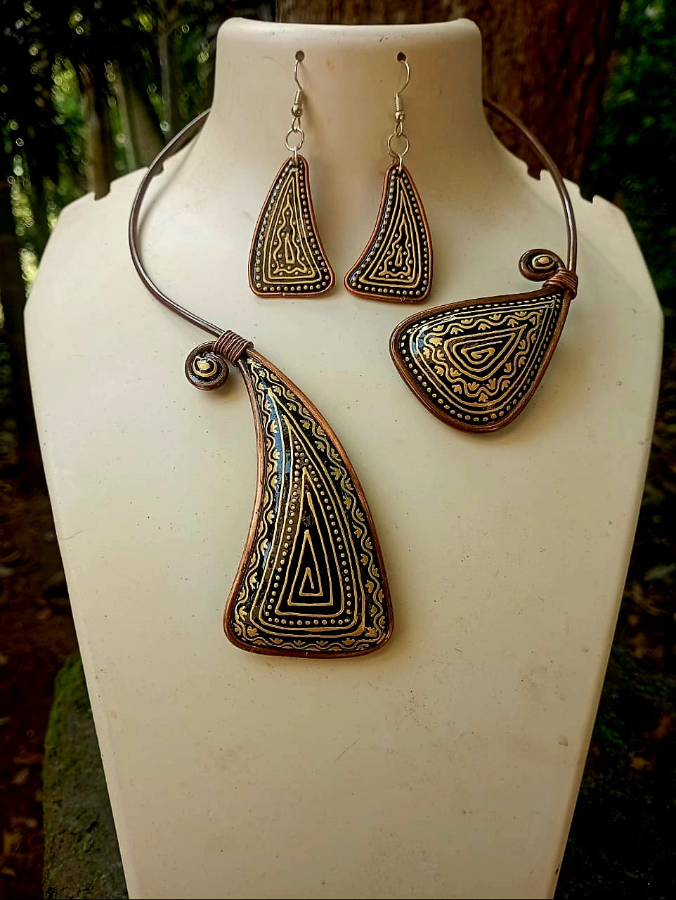 Jewelry set with necklace and earrings on a mannequin bust.