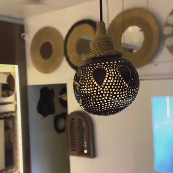 Decorative hanging light bulb with intricate design in a room setting