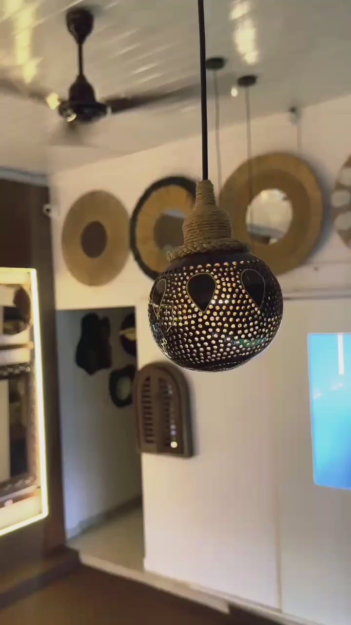 Decorative hanging light bulb with intricate design in a room setting