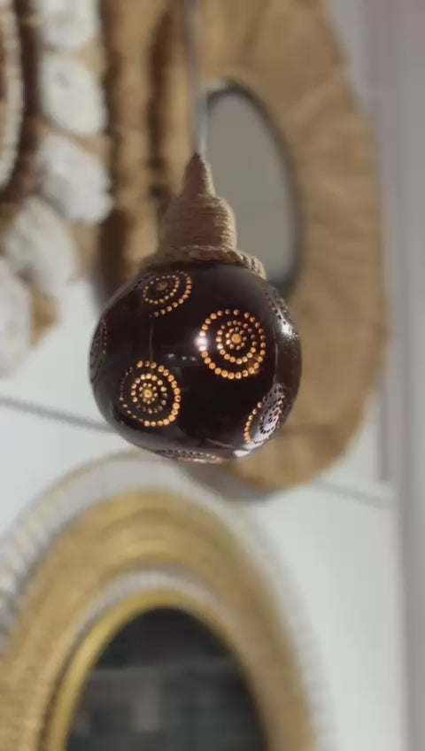 Decorative light bulb with intricate design on a blurred background