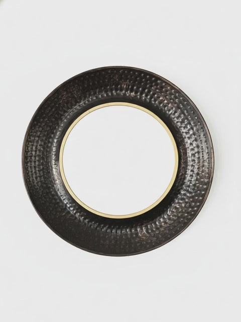 Round black textured object on a white background