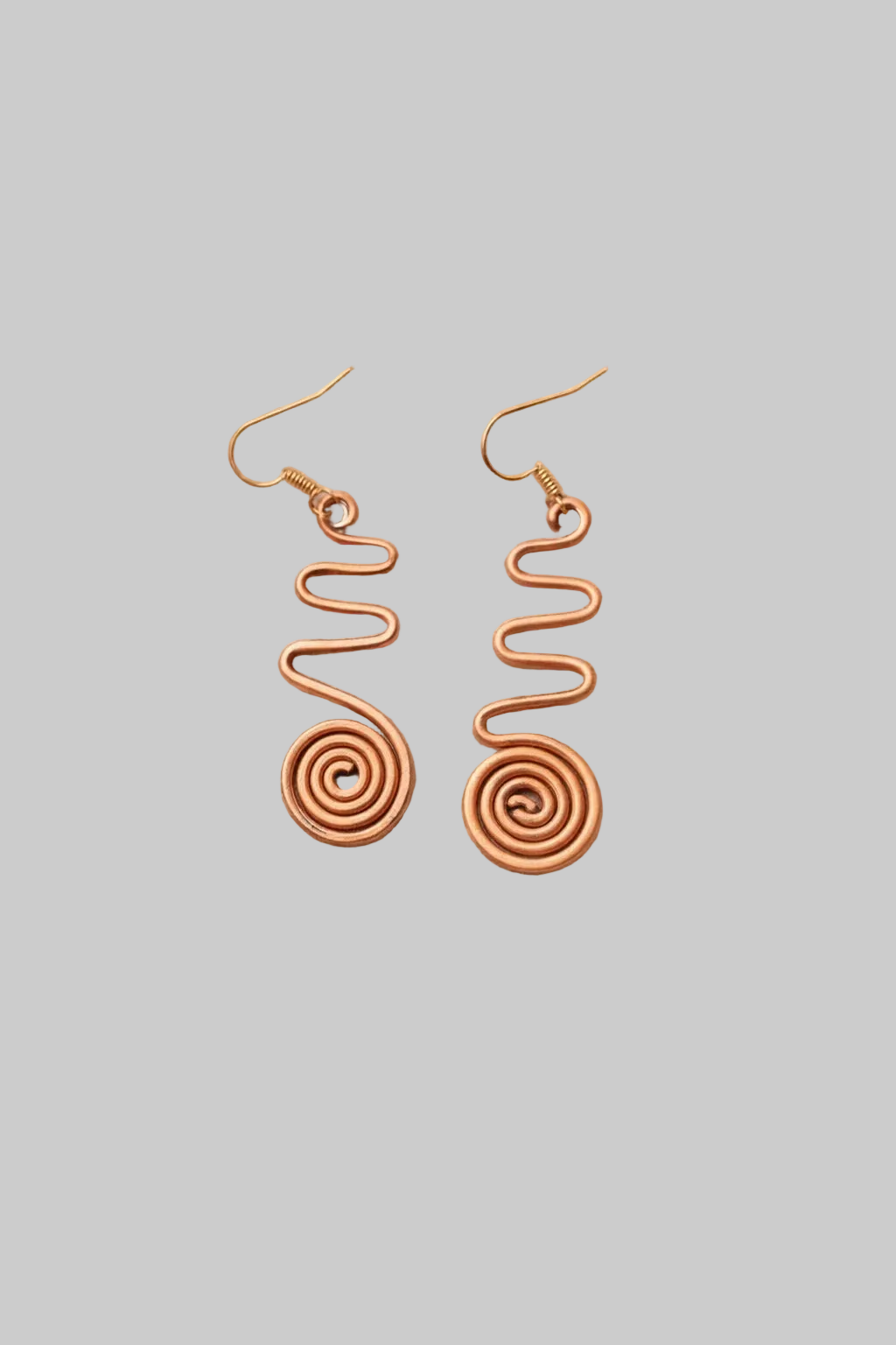 Pair of spiral-shaped earrings on a light gray background