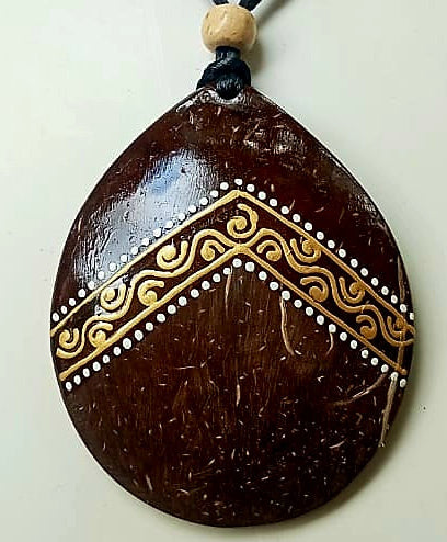 Decorative pendant with tribal patterns on a white background