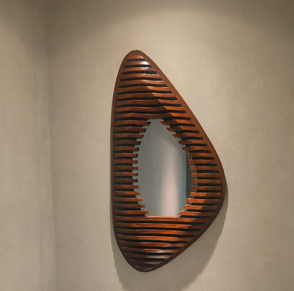 Wooden wall art with slatted design on a beige wall