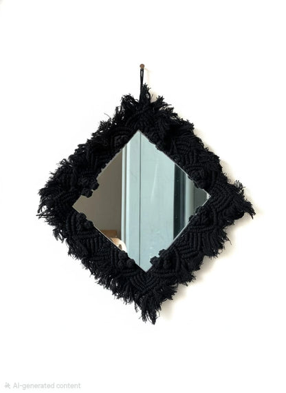 Black macramé-framed mirror on a white background