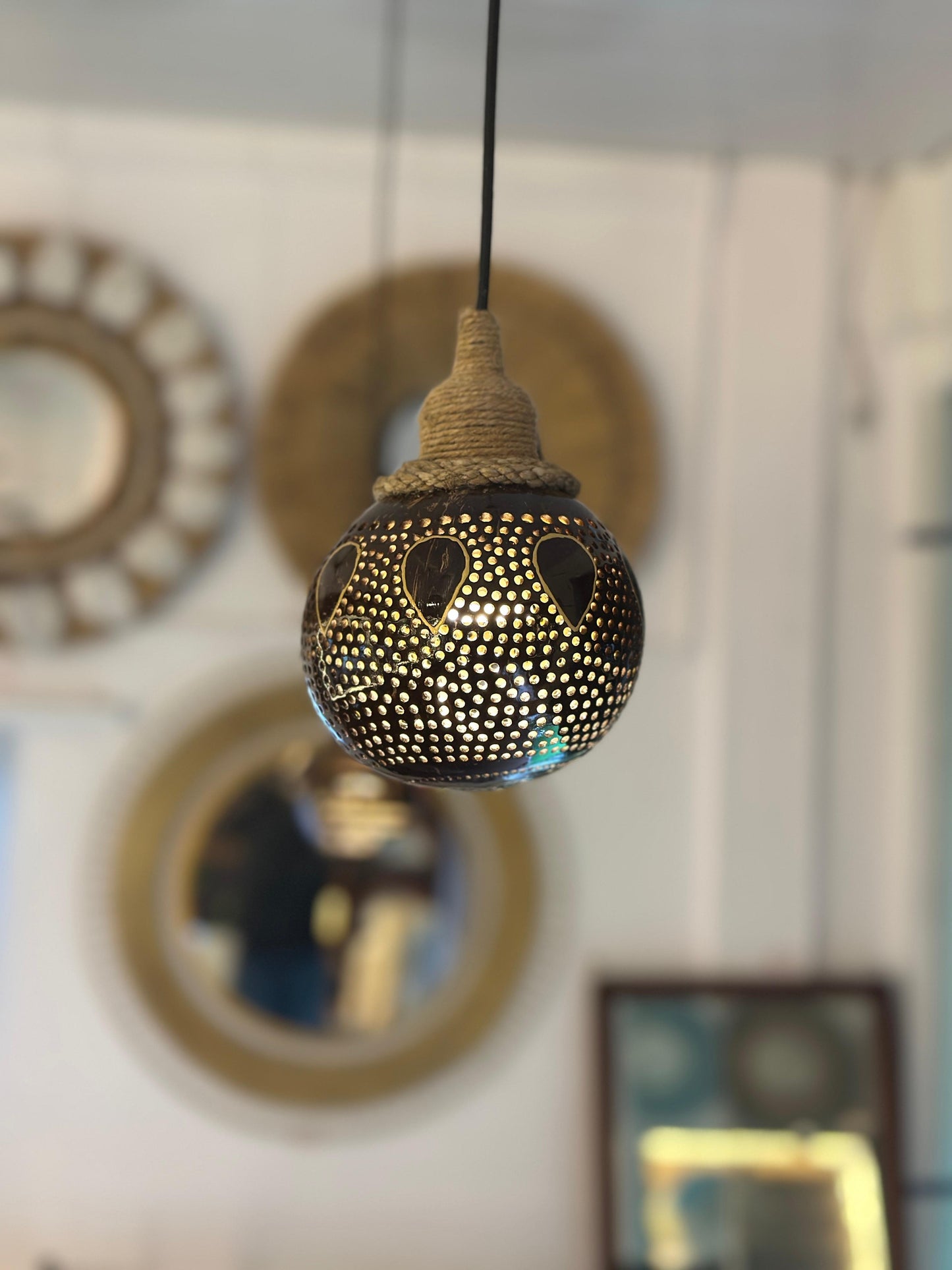 Decorative hanging light bulb with intricate design in a room setting