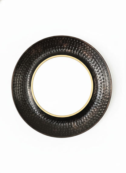 Round black textured object on a white background