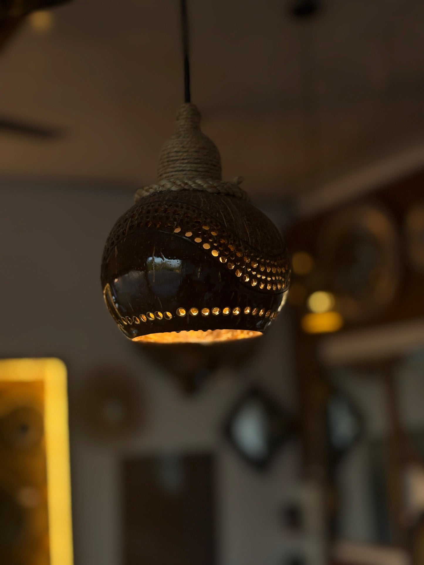 Decorative pendant light hanging in a softly blurred indoor setting
