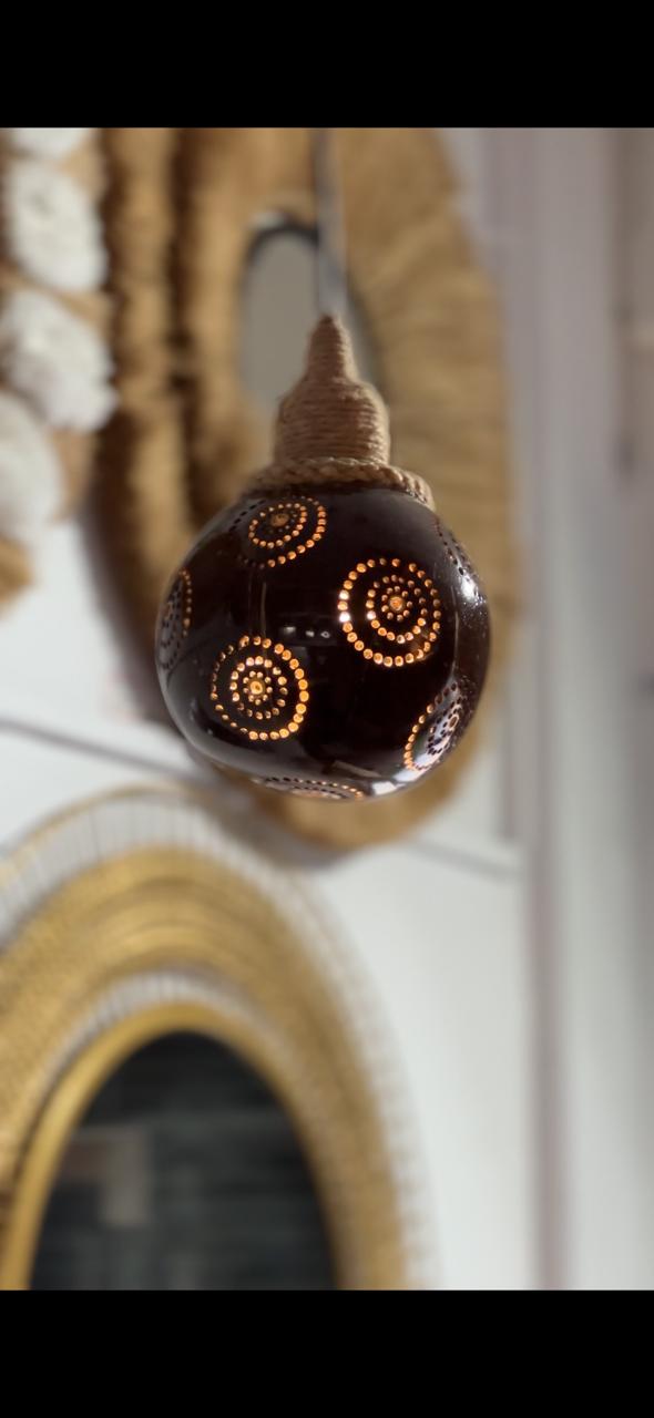 Decorative light bulb with intricate design on a blurred background