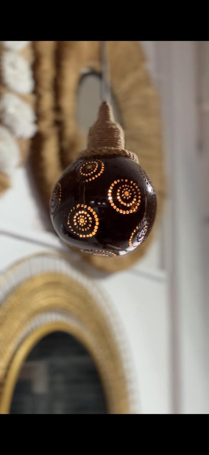 Decorative light bulb with intricate design on a blurred background