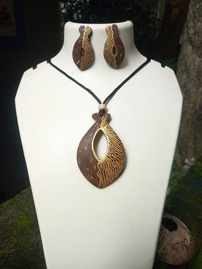 Jewelry set with pendant and earrings on a white stand.
