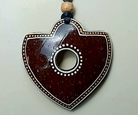 Heart-shaped pendant with a central hole on a white background