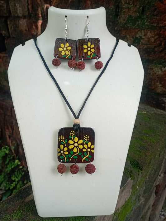 Jewelry set with pendant and earrings on a white mannequin bust.