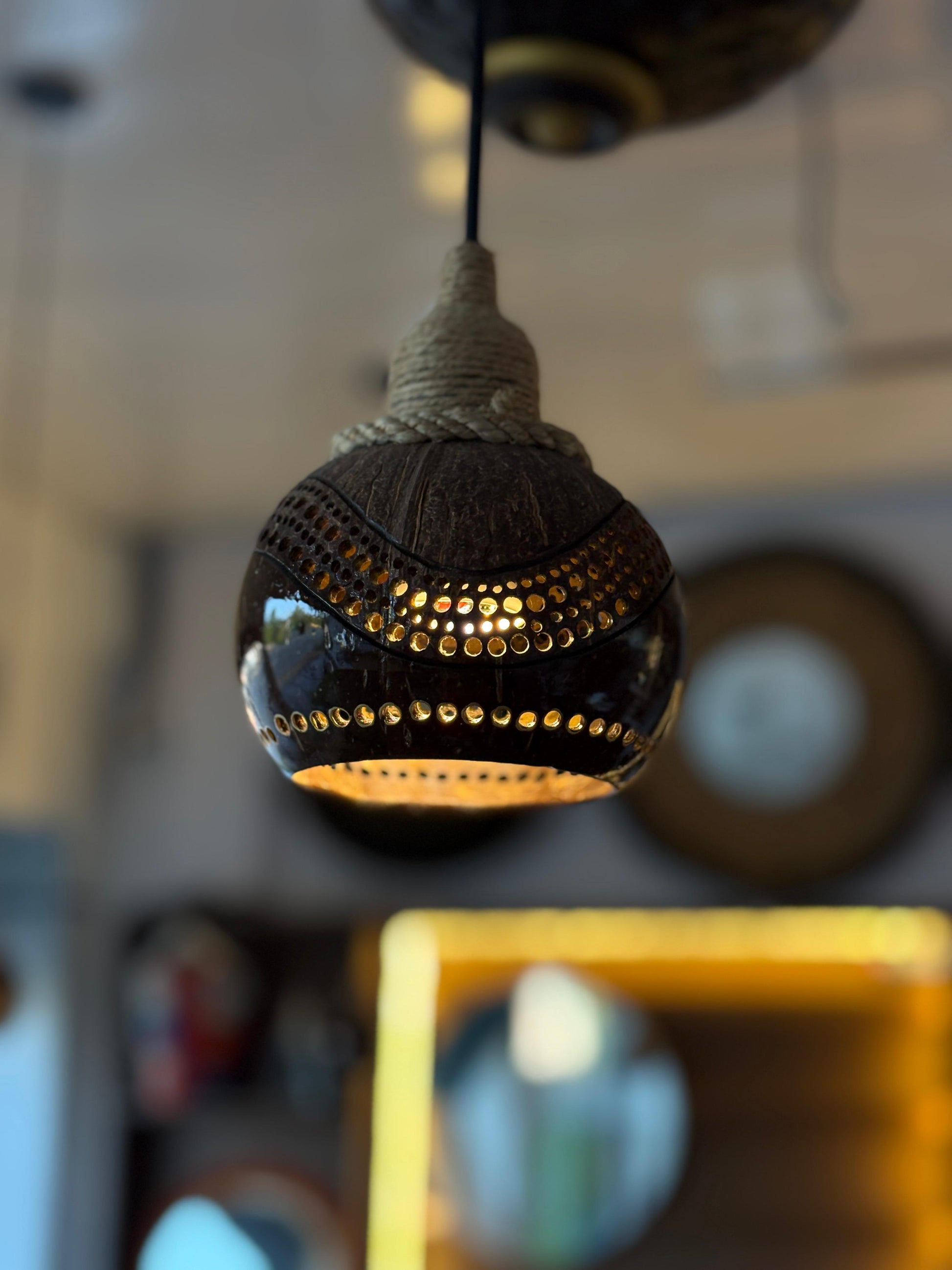 Decorative light fixture with intricate design on a blurred background